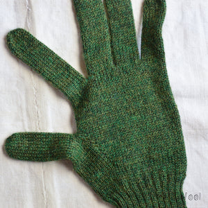 Green knitted glove on a white background